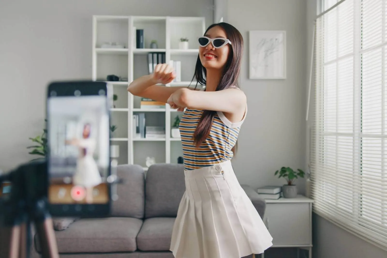 a young girl recording herself dance