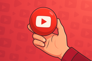 Hand holding a red YouTube play button icon on a patterned red background.